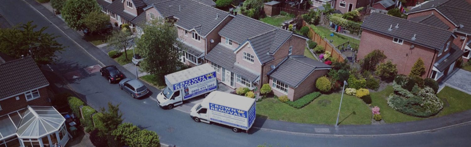 Crown Removals vans parked on a residential street ahead of a Cheshire house move Crown Removals vans parked on a residential street ahead of a Cheshire house move