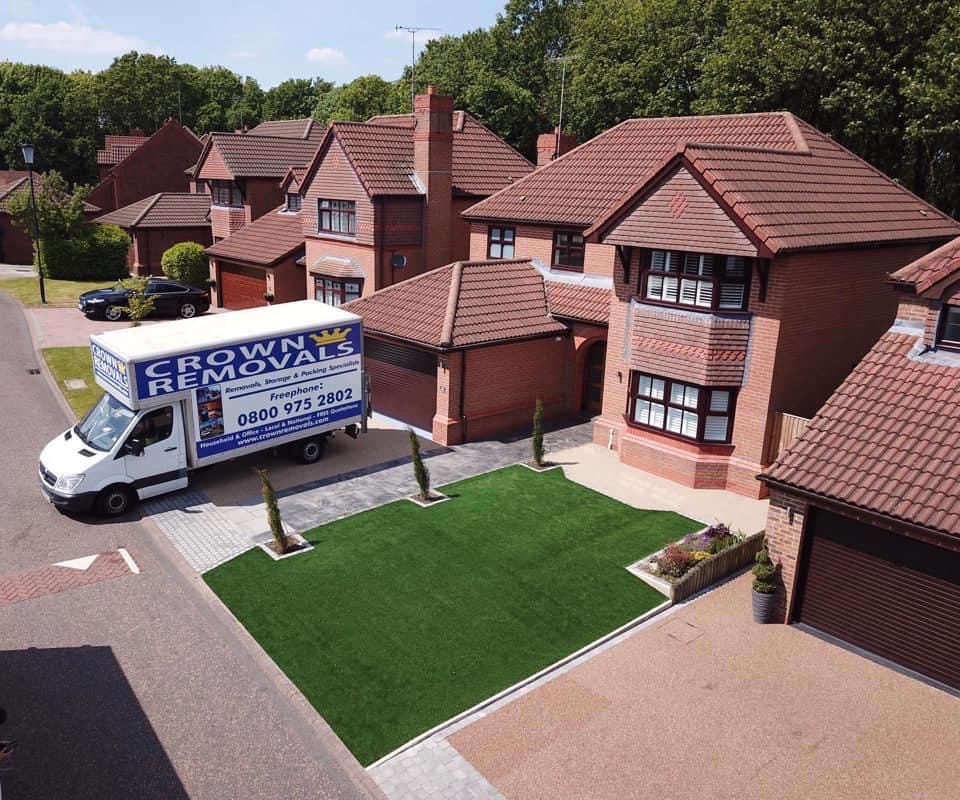 Crown Removals van outside a family home on a new build estate Crown Removals van outside a family home on a new build estate